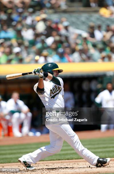 Jed Lowrie of the Oakland Athletics bats during the game against the Houston Astros at the Oakland Alameda Coliseum on June 14, 2018 in Oakland,...