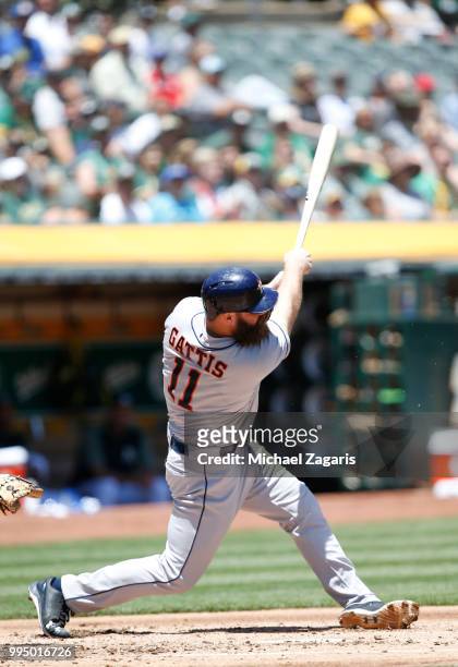 Evan Gattis of the Houston Astros bats during the game against the Oakland Athletics at the Oakland Alameda Coliseum on June 14, 2018 in Oakland,...