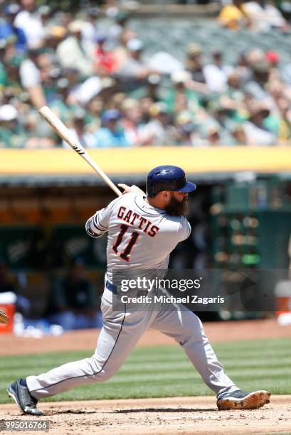 Evan Gattis of the Houston Astros bats during the game against the Oakland Athletics at the Oakland Alameda Coliseum on June 14, 2018 in Oakland,...