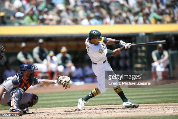 Khris Davis of the Oakland Athletics hits a home run during the game against the Houston Astros at the Oakland Alameda Coliseum on June 14, 2018 in...