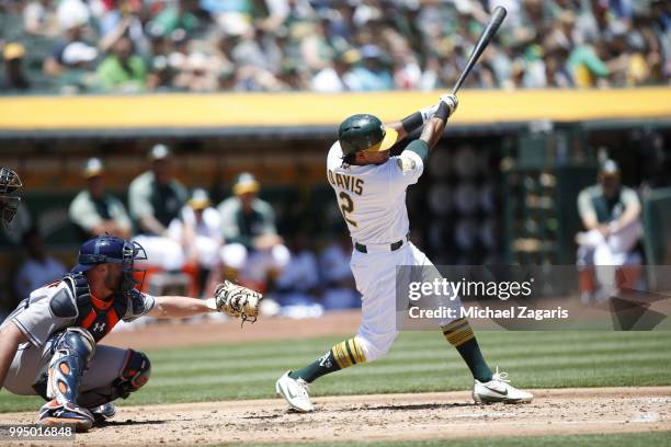 Khris Davis of the Oakland Athletics hits a home run during the game against the Houston Astros at the Oakland Alameda Coliseum on June 14, 2018 in...