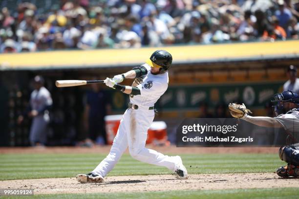 Jed Lowrie of the Oakland Athletics bats during the game against the Houston Astros at the Oakland Alameda Coliseum on June 14, 2018 in Oakland,...