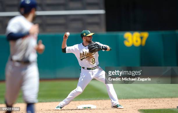 Jed Lowrie of the Oakland Athletics fields during the game against the Houston Astros at the Oakland Alameda Coliseum on June 14, 2018 in Oakland,...
