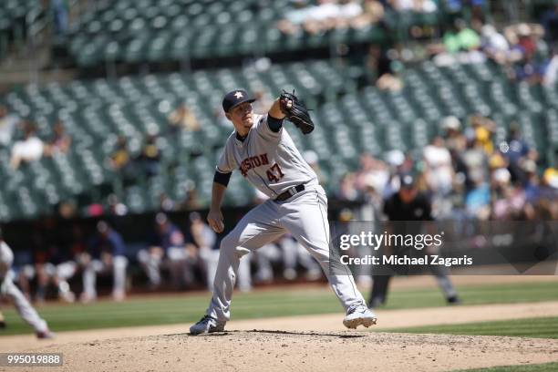 Chris Devenski of the Houston Astros pitches during the game against the Oakland Athletics at the Oakland Alameda Coliseum on June 14, 2018 in...