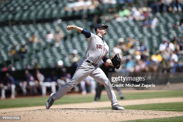 Chris Devenski of the Houston Astros pitches during the game against the Oakland Athletics at the Oakland Alameda Coliseum on June 14, 2018 in...