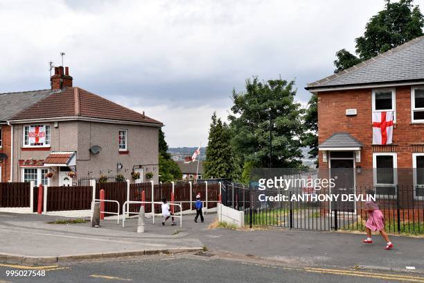 England flags decorate houses in Sheffield, northern England, on July 9, 2018 the birthplace of England's Kyle Walker, Harry Maguire and Jamie Vardy,...