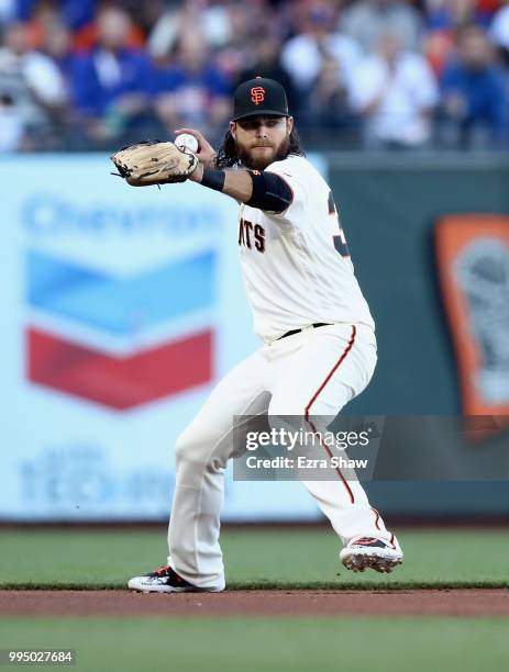 Brandon Crawford of the San Francisco Giants throws the ball to first base on a ball hit by Albert Almora Jr. #5 of the Chicago Cubs in the first...