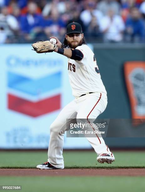 Brandon Crawford of the San Francisco Giants throws the ball to first base on a ball hit by Albert Almora Jr. #5 of the Chicago Cubs in the first...