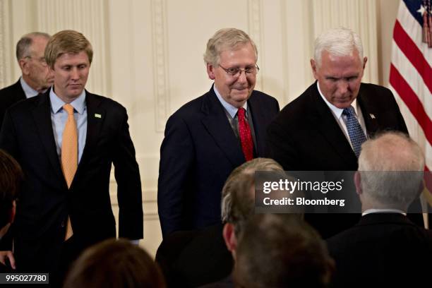 Senate Majority Leader Mitch McConnell, a Republican from Kentucky, center, and U.S. Vice President Mike Pence, right, attend the U.S. Supreme Court...