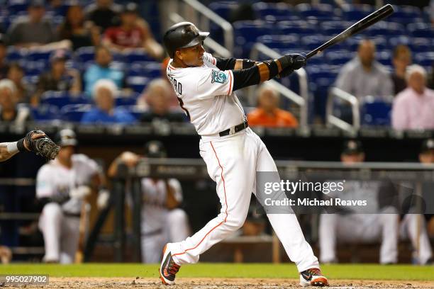 Starlin Castro of the Miami Marlins hits a solo home run in the seventh inning against the Milwaukee Brewers at Marlins Park on July 9, 2018 in...