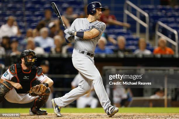 Travis Shaw of the Milwaukee Brewers hits an RBI single in the eighth inning against the Miami Marlins at Marlins Park on July 9, 2018 in Miami,...