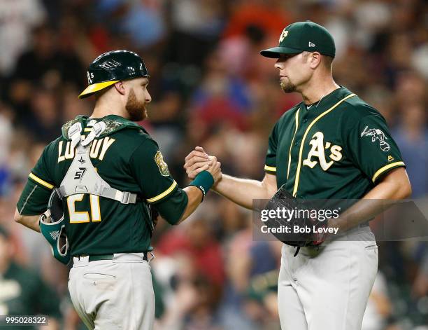 Blake Treinen of the Oakland Athletics shakes hands with catcher Jonathan Lucroy after the final out against the Houston Astros at Minute Maid Park...