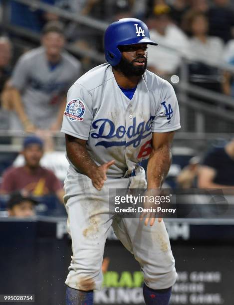 Andrew Toles of the Los Angeles Dodgers celebrates after scoring during the fourth inning of a baseball game against the San Diego Padres at PETCO...
