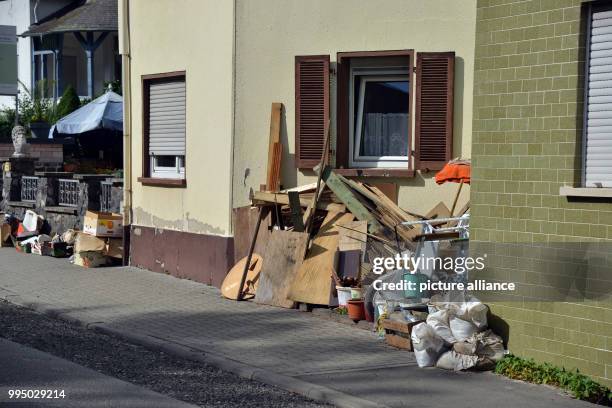 July 2018, Germany, Fischbach: The remains of the home decorations are still lying beside a house by Hunsrueck, which was affected by a storm six...