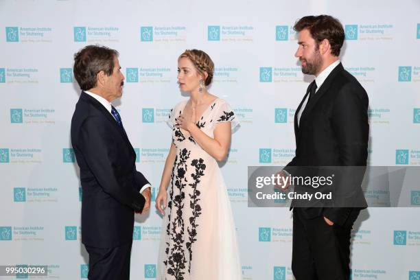 Freeing Voices Changing Lives Award recipient John Stossel, actor and AIS Gala host Emily Blunt, and actor John Krasinski attend the American...