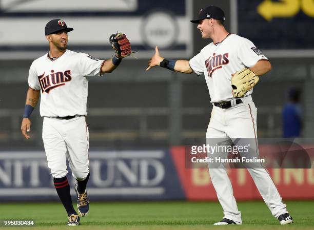 Eddie Rosario and Max Kepler of the Minnesota Twins celebrate defeating the Kansas City Royals after the game on July 9, 2018 at Target Field in...