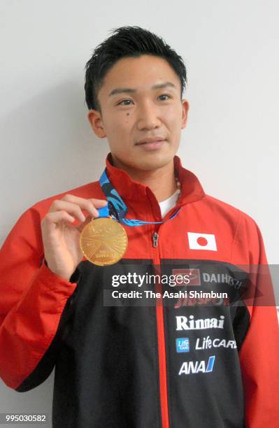 Kento Momota of Japan shows his gold medal on arrival at Haneda Airport on July 9, 2018 in Tokyo, Japan.
