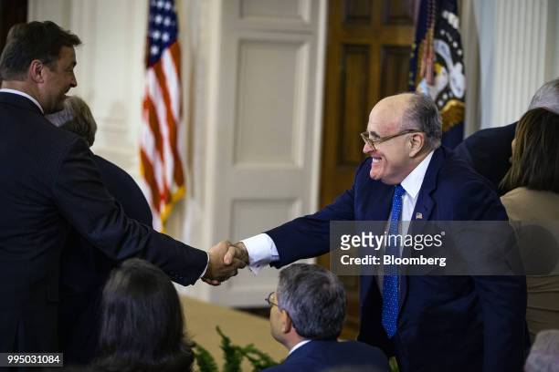 Rudy Giuliani, former mayor of New York, right, shakes hands with Senator Dean Heller, a Republican from Nevada, during the U.S. Supreme Court...