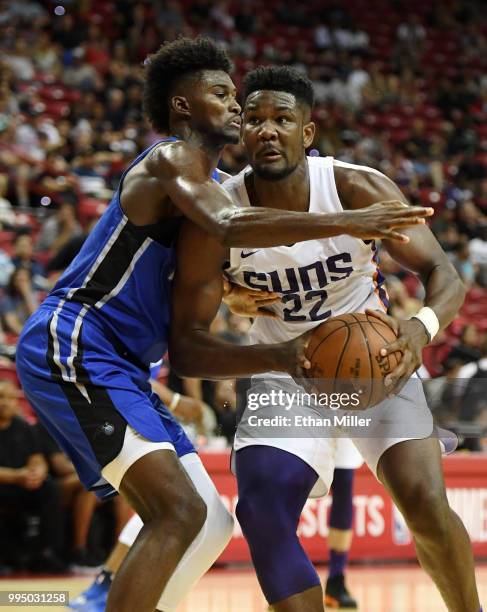 Deandre Ayton of the Phoenix Suns drives against Jonathan Isaac of the Orlando Magic during the 2018 NBA Summer League at the Thomas & Mack Center on...