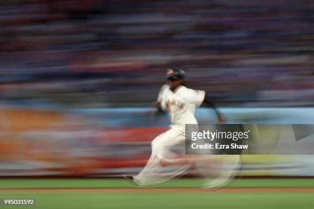 Alen Hanson of the San Francisco Giants rounds the bases to score after a failed pick off attempt in the fifth inning at AT&T Park on July 9, 2018 in...