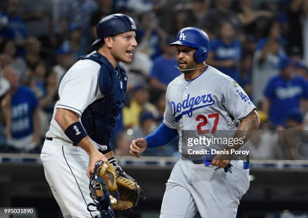 Ellis of the San Diego Padres yells as Matt Kemp of the Los Angeles Dodgers scores during the fourth inning of a baseball game at PETCO Park on July...