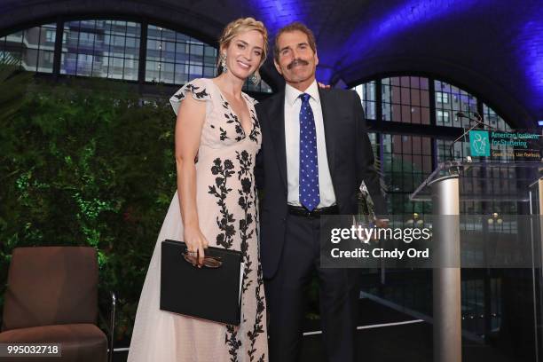 Gala host Emily Blunt and Freeing Voices Changing Lives Award recipient John Stossel pose during the American Institute for Stuttering 12th Annual...