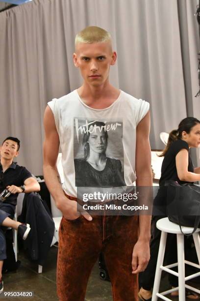 Models get ready backstage at the Carlos Campos show - Runway - July 2018 New York City Men's Fashion Week at Industria Studios on July 9, 2018 in...