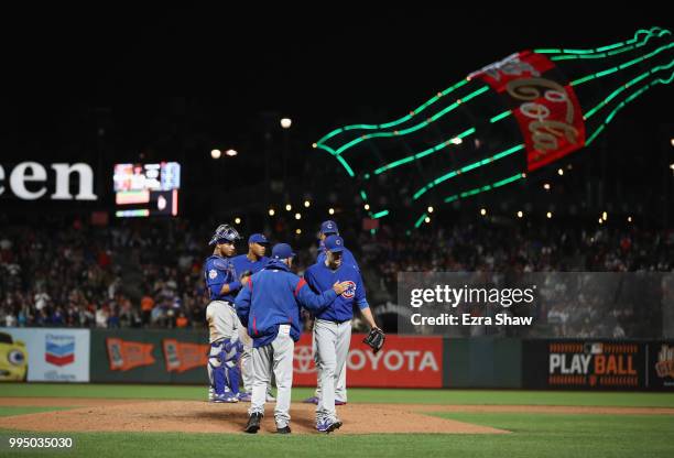 Kyle Hendricks of the Chicago Cubs is taken out of the game by manager Joe Maddon in the ninth inning against the San Francisco Giants at AT&T Park...