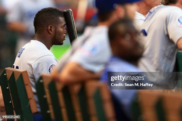 Yasiel Puig of the Los Angeles Dodgers looks on from the bench during the ninth inning of a game against the Los Angeles Angels of Anaheim at Angel...