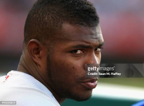 Yasiel Puig of the Los Angeles Dodgers looks on from the bench during the ninth inning of a game against the Los Angeles Angels of Anaheim at Angel...