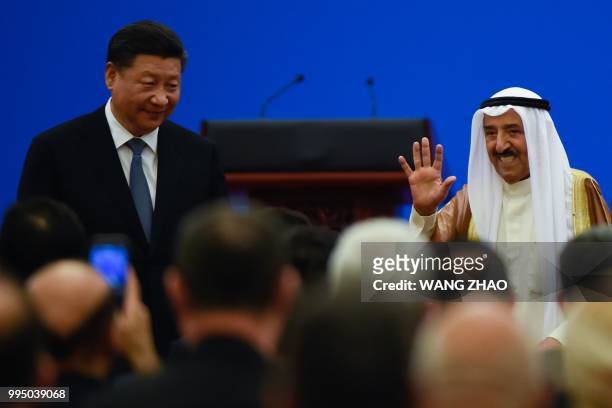 Kuwaiti ruling Emir Sheikh Sabah al-Ahmad al-Jaber al-Sabah waves after giving a speech as China's President Xi Jinping looks on, during the 8th...