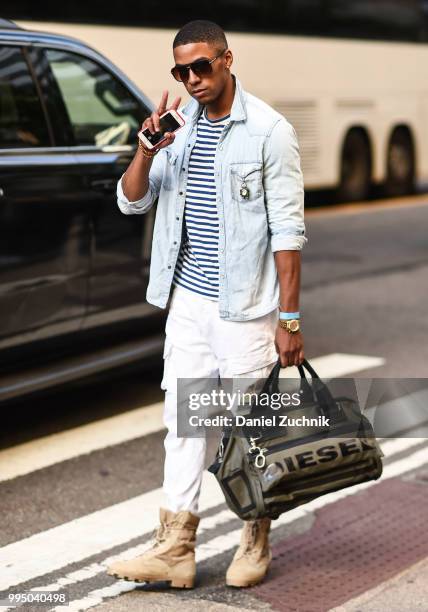 Guest is seen wearing a jean top, striped shirt, white pants and a Diesel bag outside New York Men's Day during the 2018 New York City Men's Fashion...