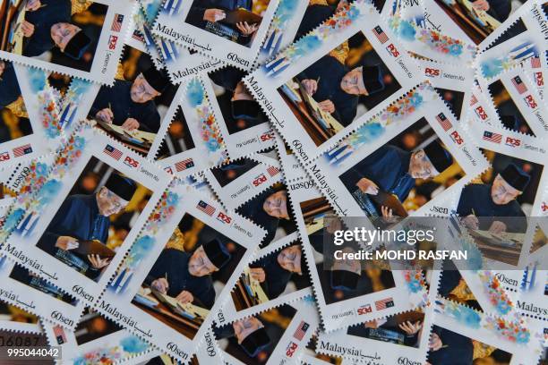 Limited edition postage stamps depicting Malaysia's Prime Minister Mahathir Mohamad are seen for sale during his 93rd birthday celebrations, at a...