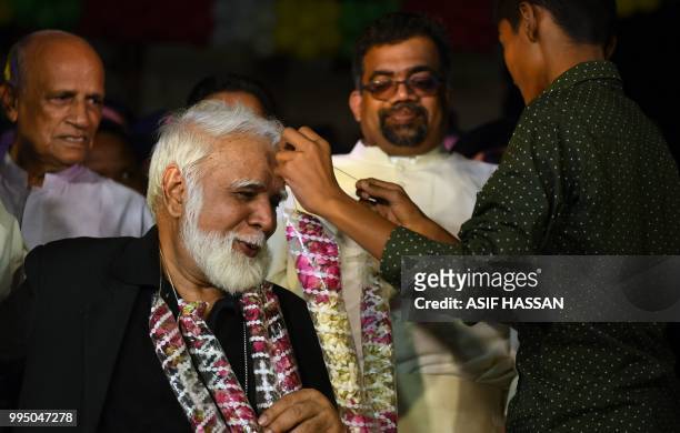 Pakistani Christian youth garlands the newly-appointed Pakistani Cardinal Joseph Coutts during a welcoming ceremony at Saint Patrick Church in...