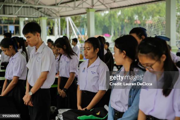 Classmates of the Wild Boars soccer team pray at the Maisai Prasitsart school before classes the morning as the third rescue mission to free the last...