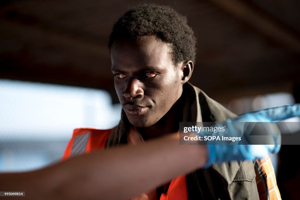 A Sub saharan migrant seen waiting to be registered by Red...