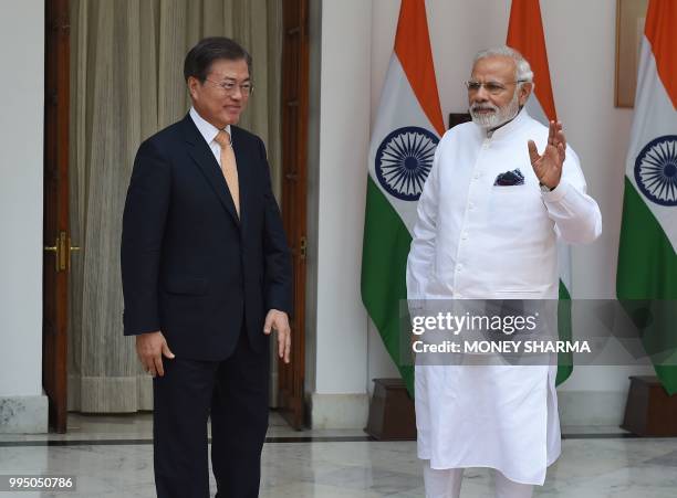 Indian Prime Minister Narendra Modi stands with South Korean President Moon Jae-in during his official visit in New Delhi on July 10, 2018. - Moon...