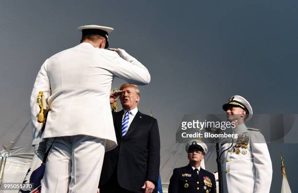 President Donald Trump, second left, salutes an admiral during a U.S. Coast Guard Change-of-Command Ceremony at the Coast Guard headquarters in...