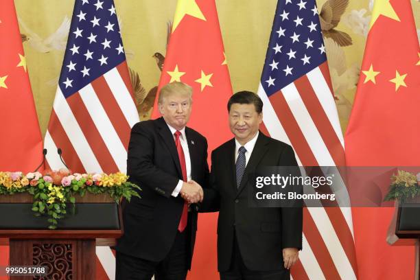President Donald Trump, left, and Xi Jinping, China's president, shake hands during a news conference at the Great Hall of the People in Beijing,...