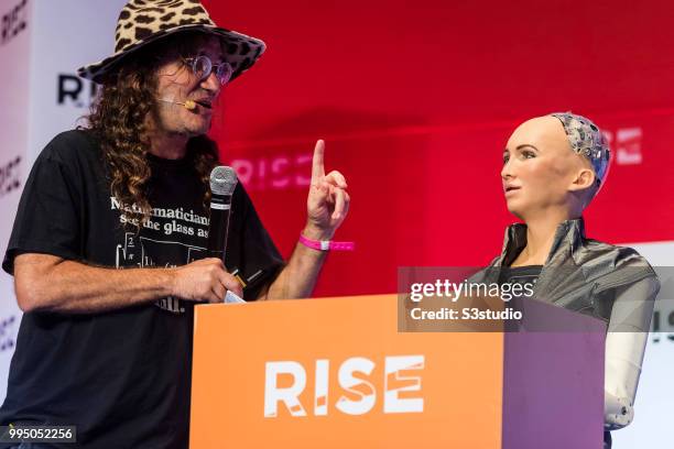 Sophia The Robot, robot of Hanson Robotics, talks to Ben Goertzel, founder and chief executive officer of SingularityNET, during the Day 1 of the...