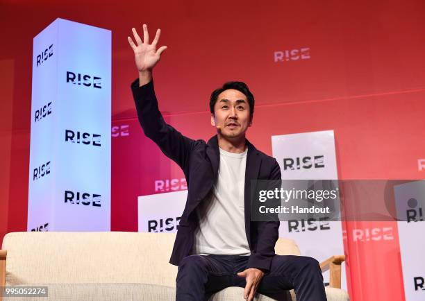 In this handout image provided by RISE, Takeshi Idezawa CEO of LINE Corporation speaks on centre stage during day one of RISE 2018 at Hong Kong...