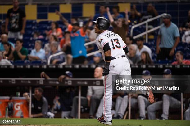 Fan cheer as Starlin Castro of the Miami Marlins hits a home run during the game against the Milwaukee Brewers at Marlins Park on July 9, 2018 in...