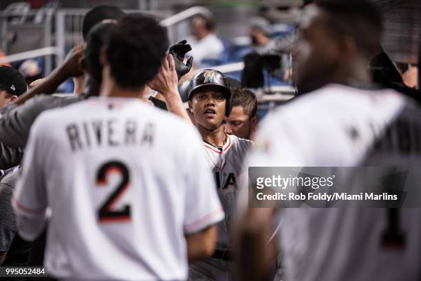 Starlin Castro of the Miami Marlins celebrates in the dugout after hitting a home run during the game against the Milwaukee Brewers at Marlins Park...
