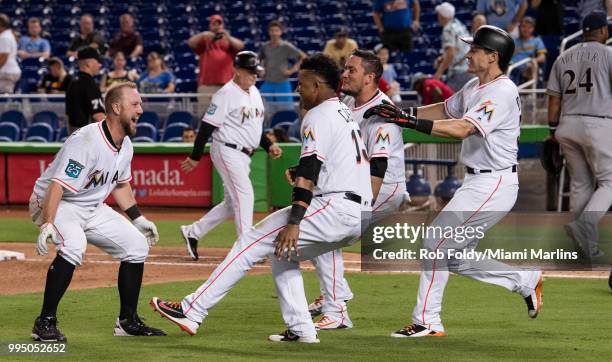 Bryan Holaday of the Miami Marlins celebrates after hitting a walk-off single to end the game against the Milwaukee Brewers at Marlins Park on July...