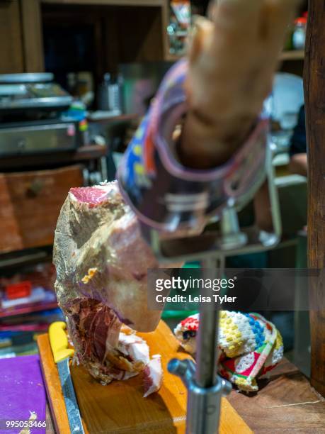 Jamon serrano ham used for tapas in Bodega El Atroje, a small bar in the town of Capileira, Spain. Grazing on acorns in the surrounding mountains,...