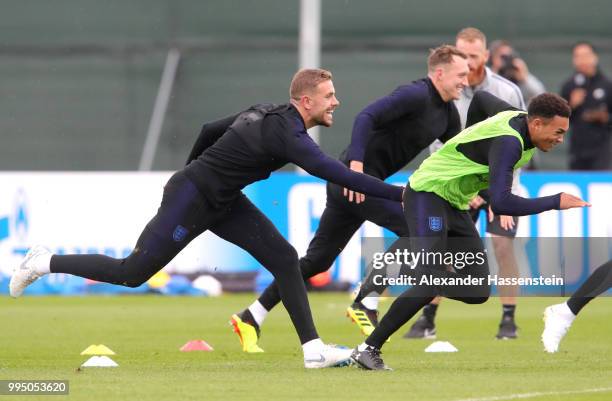 Jordan Henderson of England attempts to catch Trent Alexander-Arnold of England during the England training session on July 10, 2018 in Saint...