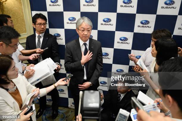 Tomomi Nakamura, president of Subaru Corp., center, speaks to members of the media after a news conference in Tokyo, Japan, on Tuesday, July 10,...