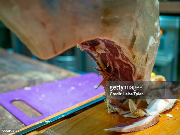 Jamon serrano ham used for tapas in Bodega El Atroje, a small bar in the town of Capileira, Spain. Grazing on acorns in the surrounding mountains,...