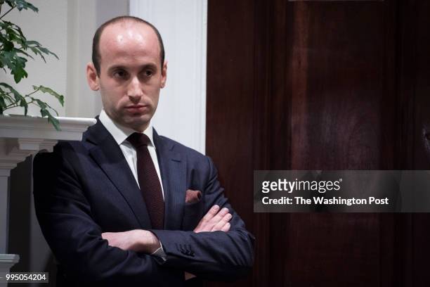 White House senior advisor Stephen Miller listens as President Donald Trump talks during a law enforcement roundtable on sanctuary cities in the...
