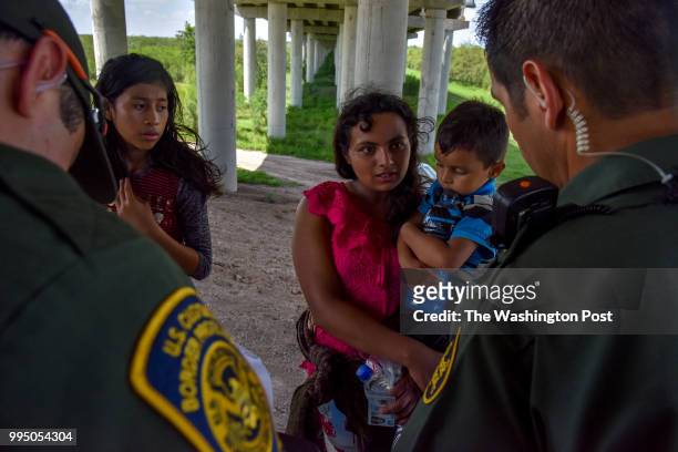 Families from Guatemala are detained by United States Border Patrol agents for illegally crossing the U.S.-Mexico border along the Rio Grande on...